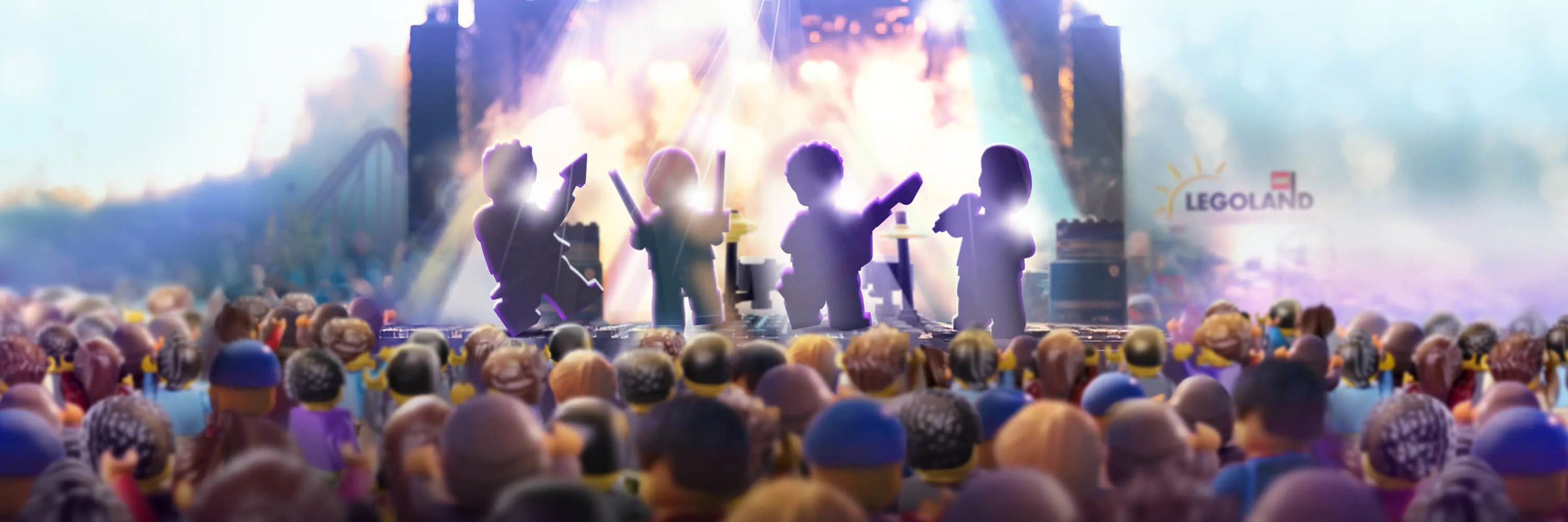 Four blurred LEGO rockstars on lit up stage with audience watching at LEGO Festival